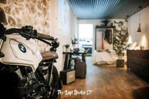 Esto si es vida apartment in Ribadesella with motorcycle, stone walls, and modern city view living space