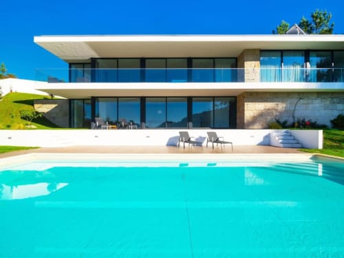 Modern luxury villa Casa da Luz Gerês with turquoise swimming pool, contemporary architecture, and mountain views in Vieira
