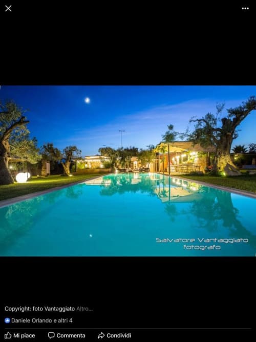 Piscina di lusso Masseria Picca Picca di notte a Morciano di Leuca, con villa illuminata, ulivi e cielo al chiarore lunare