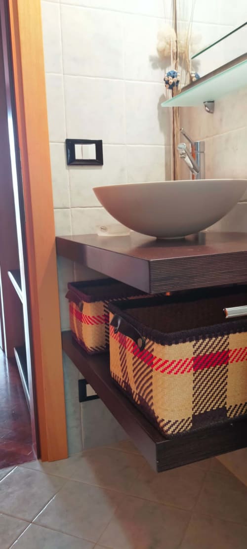 Modern bathroom sink with ceramic bowl at Casa Meravigliosa apartment in Fontanafredda, featuring wooden vanity and storage