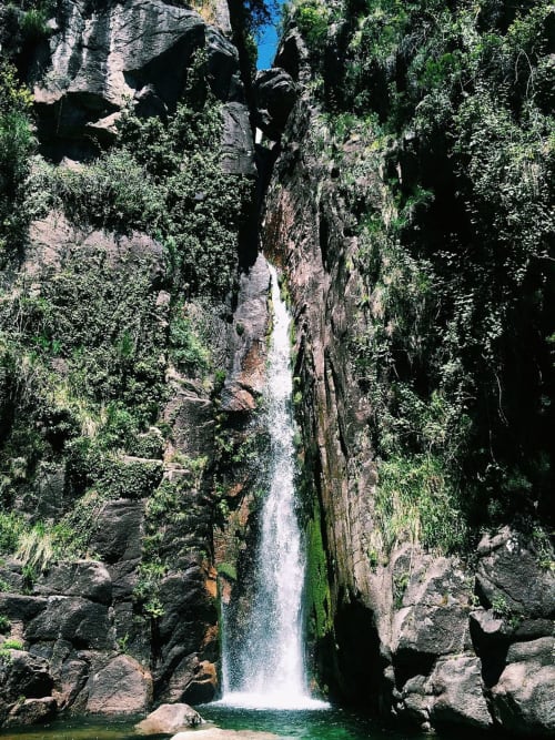 Waterfall cascading through moss-covered rocks at Casa da Luz Gerês, Vieira do Minho