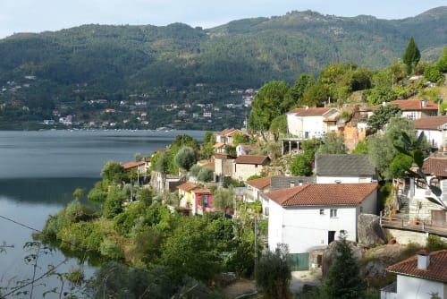 Casa da Luz Gerês hillside property overlooking calm lake with forested mountains, Vieira do Minho