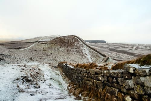 Hadrian's Wall ruins near Haydon Bridge with snowy landscape and countryside views