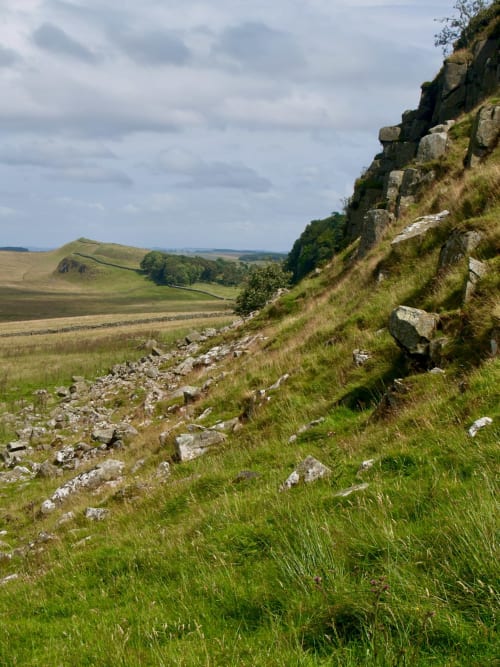 Rocky hillside with green fields near Haydon Bridge, Hexham countryside landscape