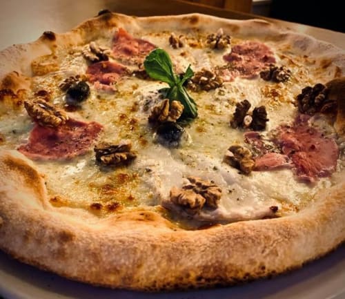 Pizza gastronomique aux noix, jambon de Parme et basilic frais à La Montagnette, Moutiers
