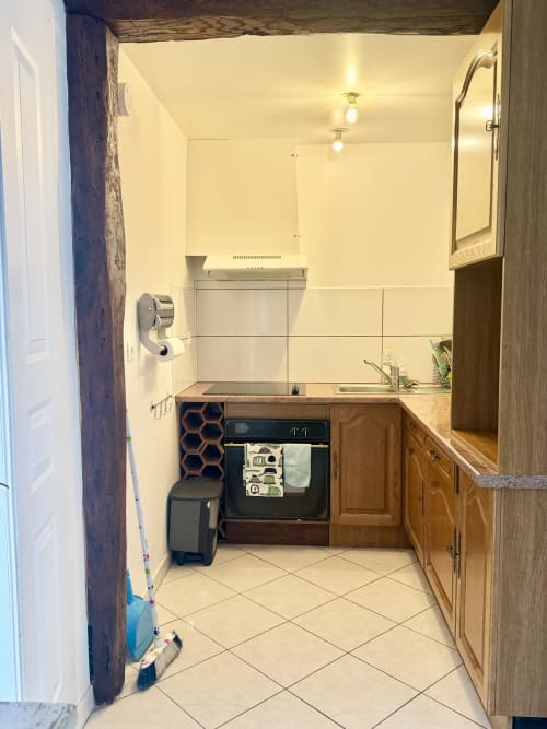 Kitchen area in Le Clos 2 cottage at Le Clos De La Vallée, Bellengreville, with wooden cabinets, electric cooker, and cream