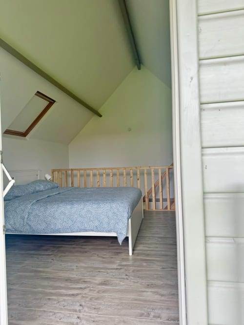 Bedroom with wooden bed and blue bedding in Le Clos 5 cottage at Le Clos De La Vallée, Bellengreville