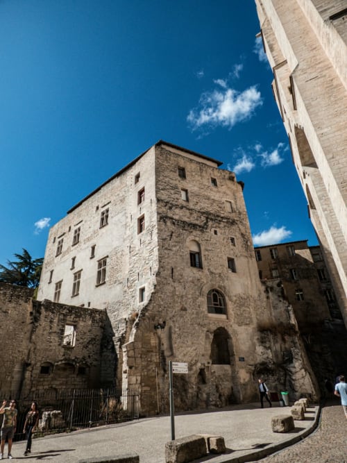 Historic stone tower at Domaine des Lavarines in Morières-lès-Avignon under blue sky