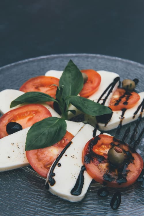 Caprese salad with fresh mozzarella, tomato slices, basil, and balsamic reduction at Domaine des Lavarines