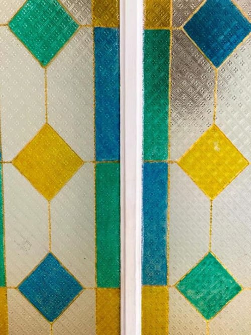 Pavimento in piastrelle geometriche colorate con motivi a rombi in blu, verde e giallo presso la guesthouse SoleMagia a Vernazzo, Italia