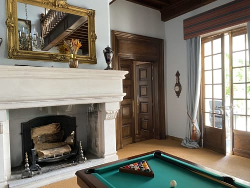 Elegant game room at Domaine de Bize Mirepoix with pool table, fireplace, and gold-framed mirror in Ariège, France