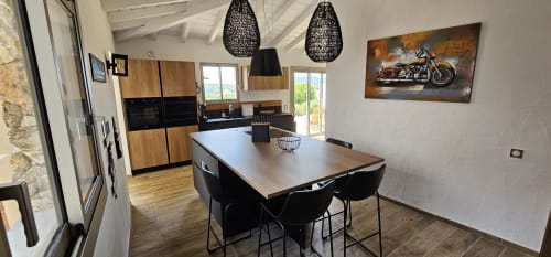 Modern kitchen and dining area in Villas-Majos villa, Sainte-Lucie de Porto-Vecchio, with wooden cabinetry and sea views