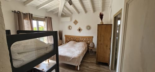 Bright villa bedroom at Villas-Majos with bunk bed, queen bed, wooden furnishings, and sea views in Porto-Vecchio