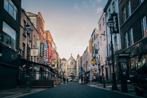 Historic Dublin street leading to cathedral, lined with shops and buildings near Dublin Exchange Suites