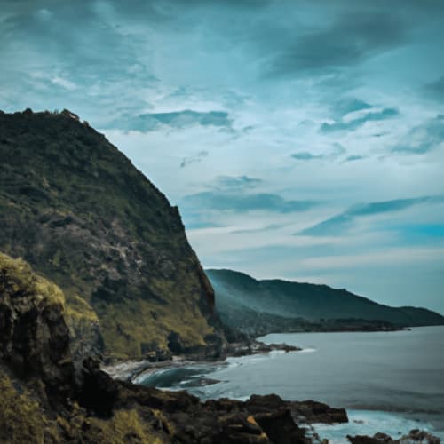 A picturesque view of Dolau Beach with cliffs and clear blue water.