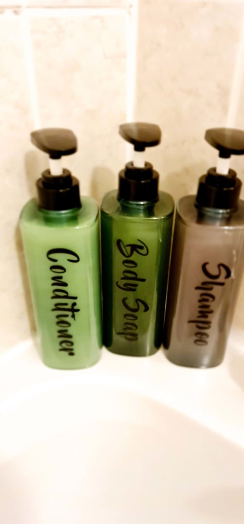 Three pump bottles of complimentary toiletries at Dublin Exchange Suites hotel, labeled Conditioner, Body Soap, and Shampoo.