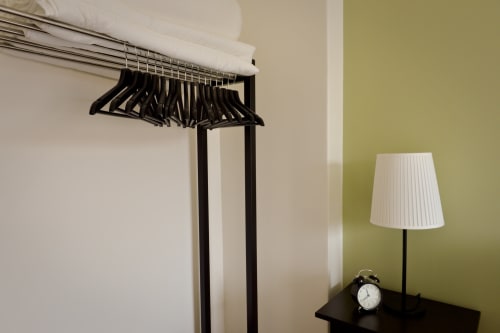 A wardrobe in the bedroom allows for hanging clothes. The house is often used for weddings in Honfleur.