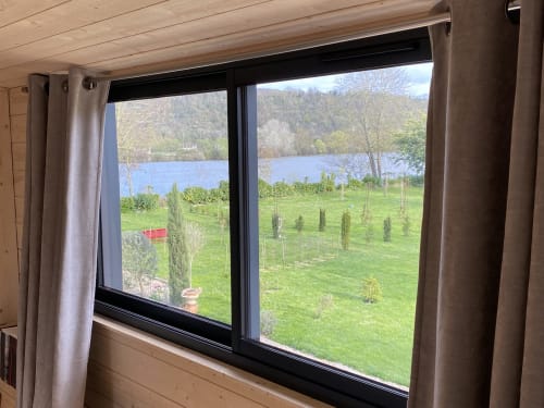 River view from The Nest cottage at Clairseine B&B overlooking Tournedos-sur-Seine with green grounds and distant trees