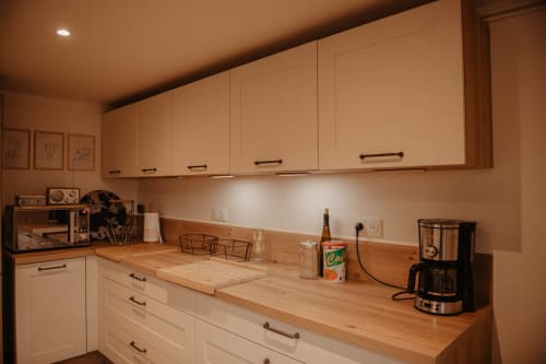 Cuisine moderne du gîte Repaire Des Darous à Saulxures sur Moselotte avec mobilier clair et comptoirs en bois