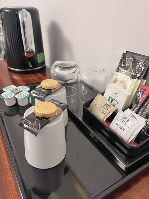 Coffee station in Cookson Deluxe Room at The Railway Hotel Haydon Bridge with kettle, cups, and condiments