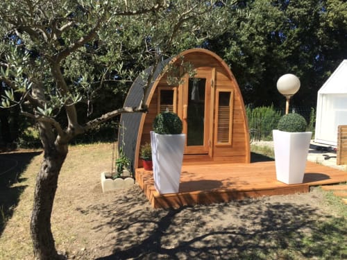 Wooden cottage with terrace at Domaine des Lavarines, Morières-lès-Avignon, surrounded by olive trees and white planters