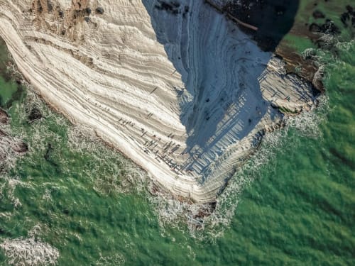 Aerial view of Licata's chalk cliffs and turquoise waters near La Maison Du Port hotel