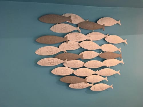 Wooden fish wall art decoration in teal room at Azur Studios Cannes