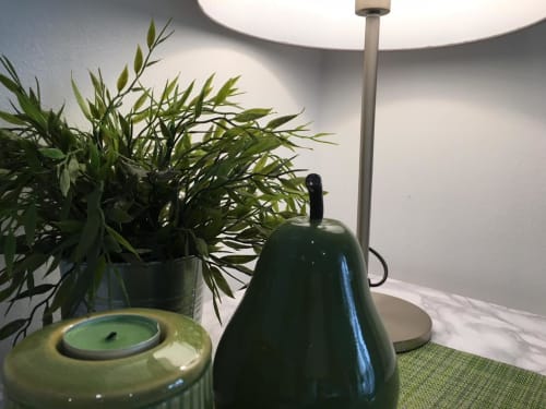 Azur Studios Cannes desk with lamp, potted plant, and green candle décor