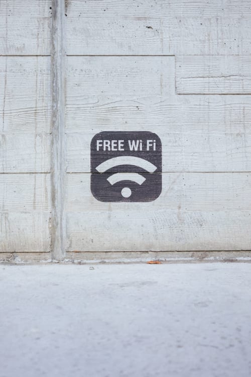 FREE WiFi symbol painted on white wooden wall at Azur Studios Cannes
