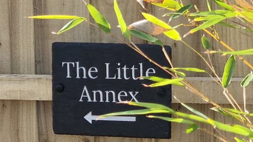 The Little Annex directional sign on wooden fence with arrow, Horsham property entrance marker