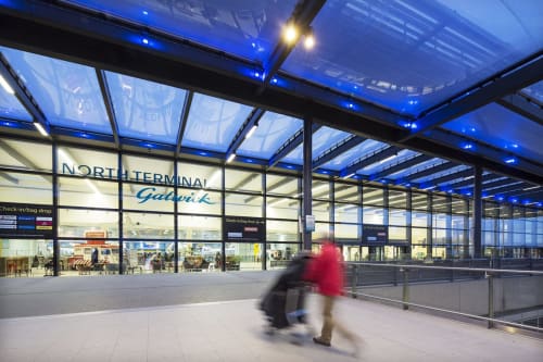 North Terminal Gatwick Airport concourse with blue lighting and modern architecture in Horsham, GB