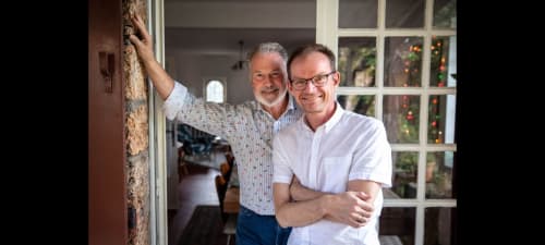 Two men smiling at doorway of La Sentinelle B&B in Les Arcs sur Argens, France