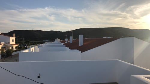 Star Host rooftop terrace with white walls overlooking Bordeira hills at sunset
