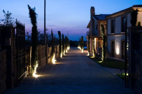 Casale 905 entrance at dusk, Crecchio, Italy - illuminated stone pathway lined with cypress trees