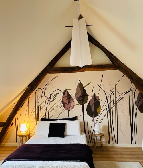 Cozy attic bedroom at Clairseine B&B with wooden beams, decorative wall mural, and ambient lighting in Tournedos-sur-Seine