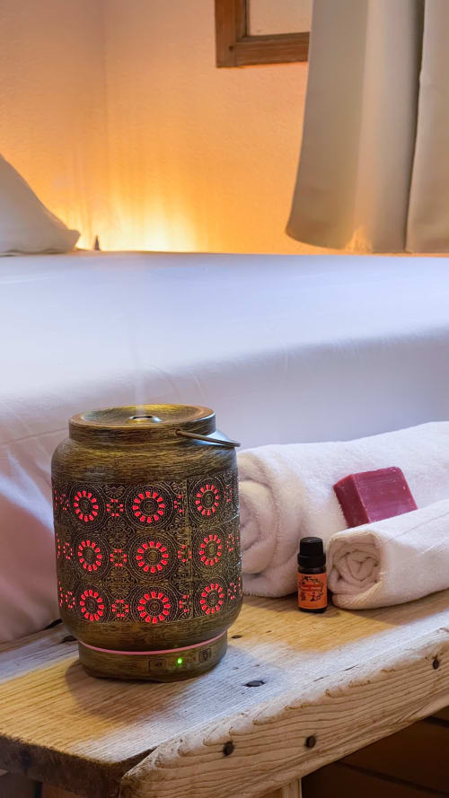 Ornate essential oil diffuser with warm glow in bedroom at Casa Rural Villa del Jerte, El Torno