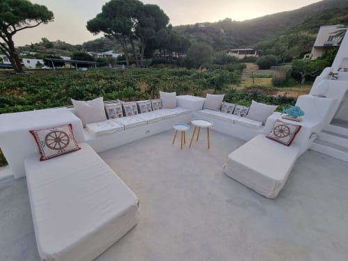 Miravilla Salina terrace lounge with white seating, cushions, side tables overlooking vineyard and hills in Santa Marina