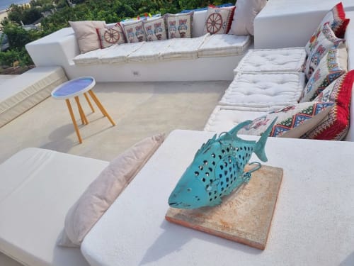 Miravilla Salina rooftop lounge with turquoise fish sculpture, white seating, and Aegean views, Santa Marina Salina