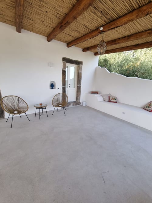 Miravilla Salina terrace with woven chairs, wooden beams, white walls and sea views in Santa Marina Salina