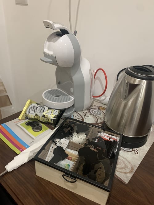 Coffee station in Maryam 23 hotel room with Nespresso machine, electric kettle, and coffee pods in Syracuse