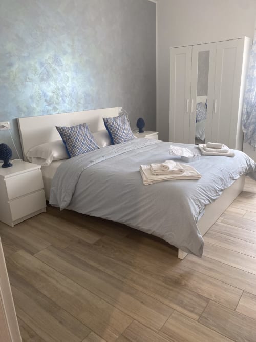 Maryam 23 B&B Blue Room Double with Window in Siracusa, Italy - modern bedroom with white furniture and city view