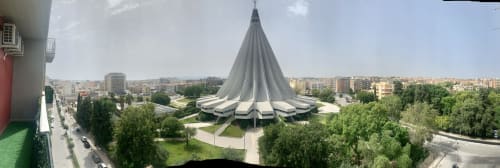 Modern tent-shaped structure with city skyline in Siracusa, Italy from hotel balcony view