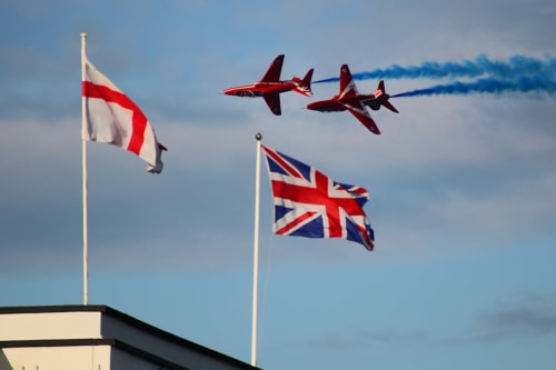 Red arrows aerobatic team flying over British and Polish flags at England Furnished Homes in High Wycombe