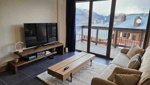 Salon moderne à L'écrin des sapins avec vue montagne, TV, cheminée et balcon à Aime-la-Plagne