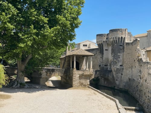 Medieval stone buildings and courtyard at Domaine des Lavarines, a French bed and breakfast in Morières-lès-Avignon