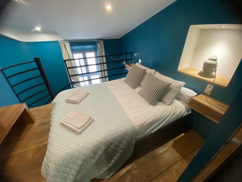 Turquoise bedroom at AJOUCADOU The Nest apartment in Lourmarin with queen bed and modern amenities