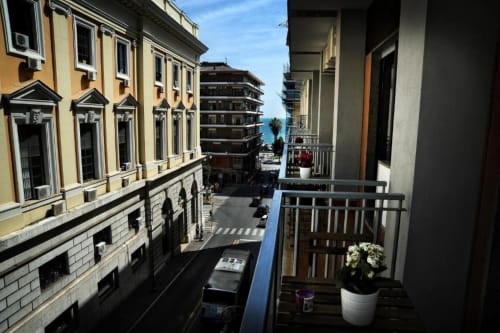 Balcony view from Casa Castagna Deluxe Room overlooking Salerno's historic architecture and Mediterranean coast