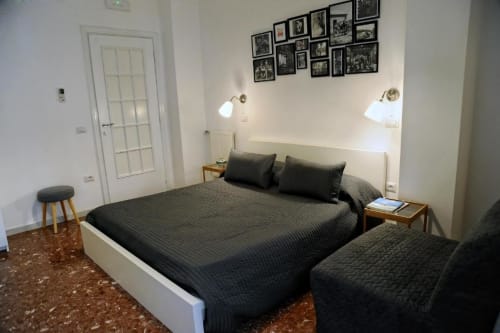 Economy double room at Casa Castagna B&B in Salerno with dark bedding, wall sconces, and inner courtyard view