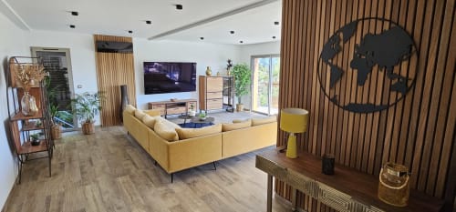 Modern villa living room at Villas-Majos with yellow sofa, flat-screen TV, wooden accents, and sea views in Sainte-Lucie de