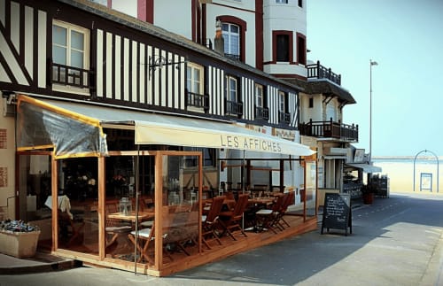 Les Affiches restaurant at Hotel Le Trouville, Trouville sur Mer, with timber-framed building and beachfront seating